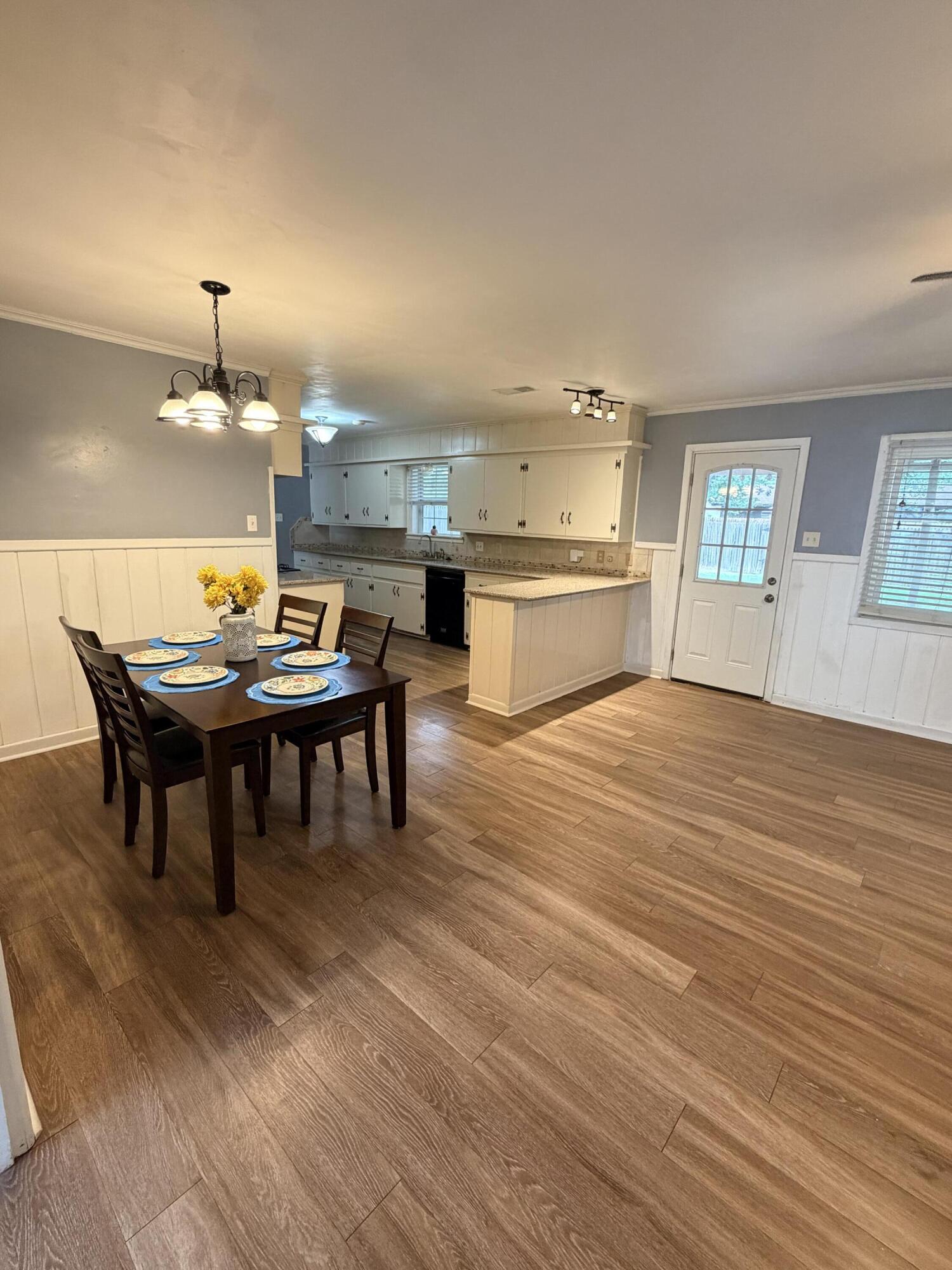 3814 27th Street Lubbock, TX 79410 - Photo 5 of 24 a view of a dining room with furniture and wooden floor