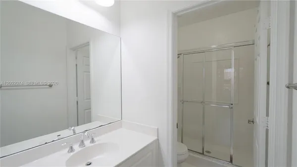 a bathroom with a shower and a sink