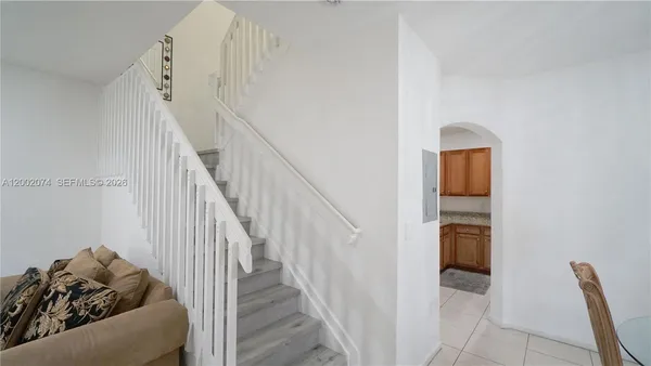 a view of a livingroom with furniture and stairs
