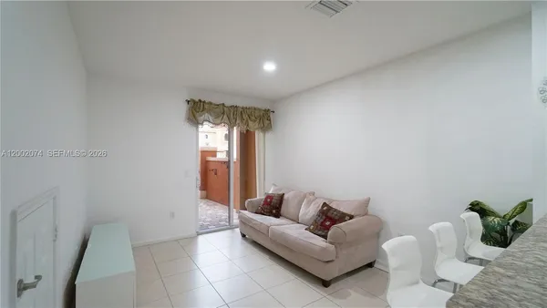 a living room with furniture and white walls