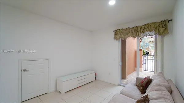a view of a bedroom with a bed and a window