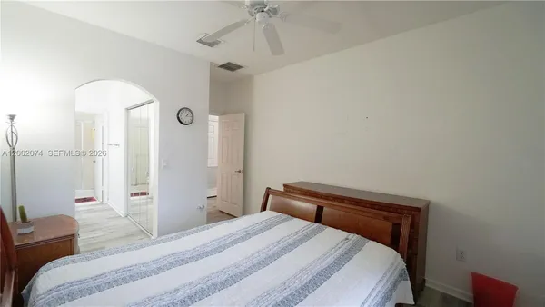 a bedroom with a bed and a chandelier