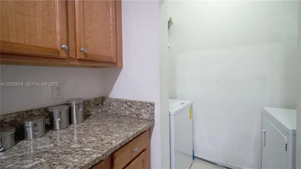 a view of a kitchen counter space and cabinets