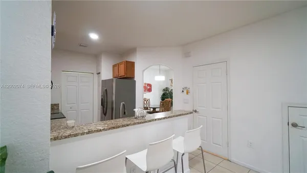a living room with a sink and a mirror