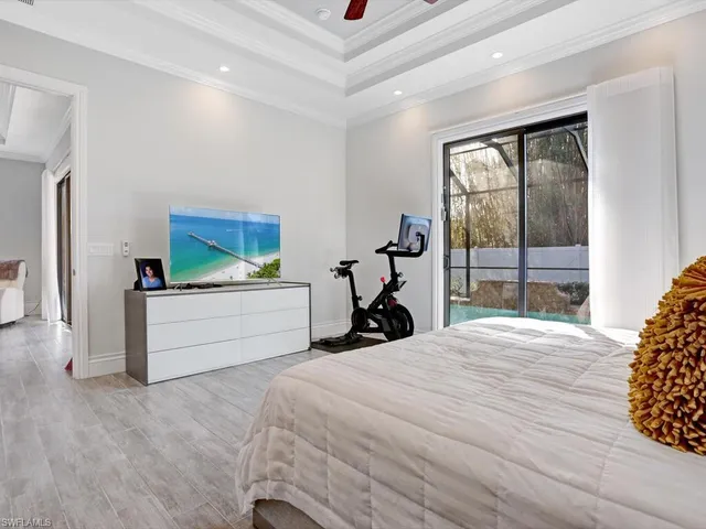 a bed room with a bed and a large window