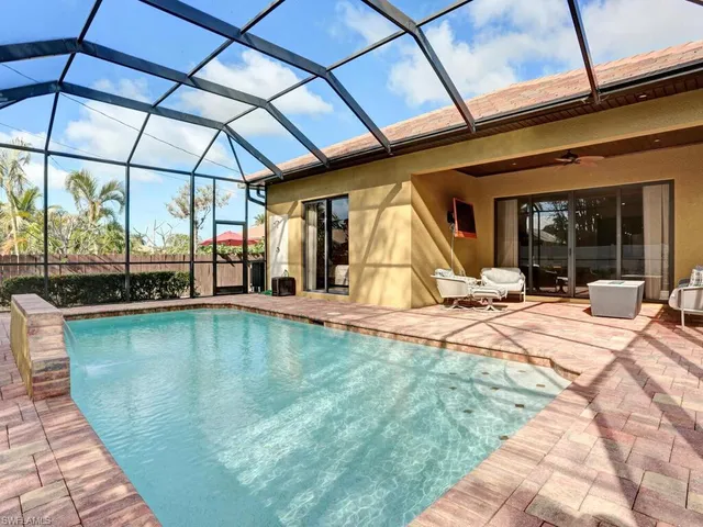 a swimming pool with an outdoor seating