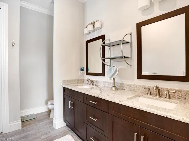 a bathroom with a double vanity sink and a mirror
