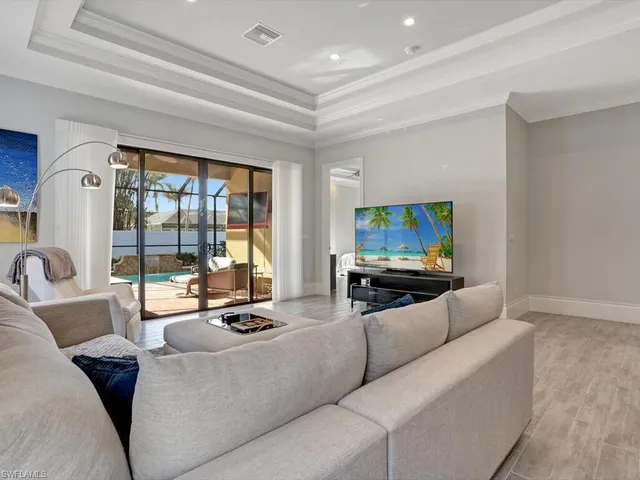 a living room with furniture tv and a large window