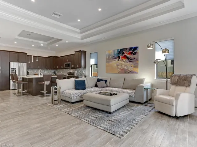 a living room with furniture and kitchen view