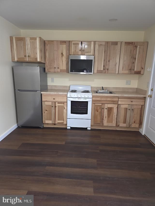 56 Valley Street Lewistown, PA 17044 - Photo 2 of 6 a kitchen with granite countertop a stove a microwave a sink and cabinets