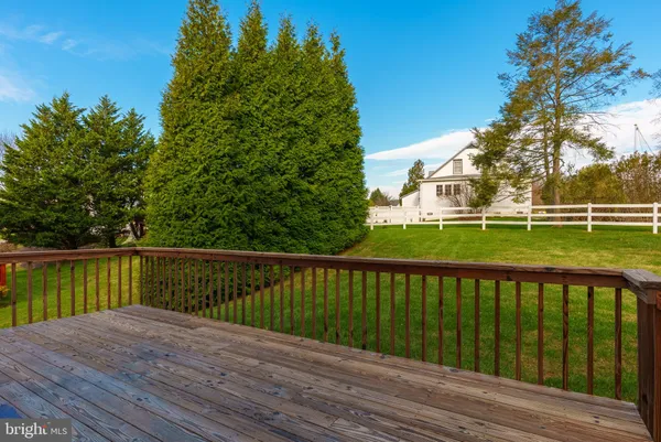 a view of a wooden deck with a yard