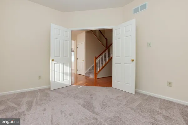 a view of an empty room with stairs