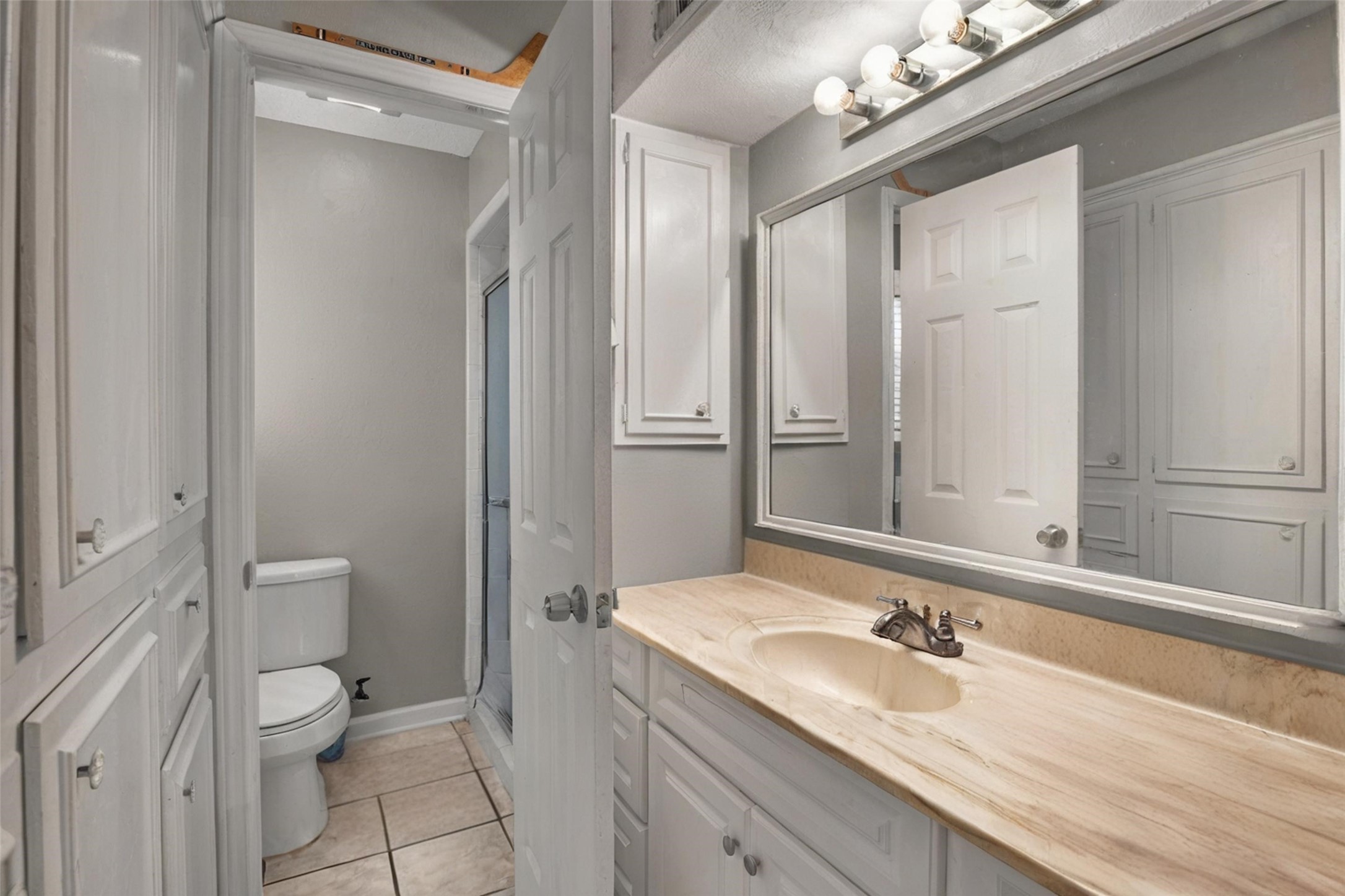 18230 Caprice Lane Houston, TX 77058 - Photo 11 of 34 a bathroom with a granite countertop sink a toilet and shower