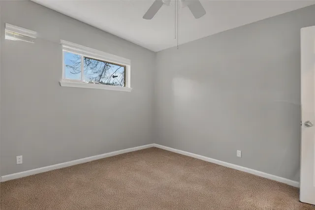 an empty room with a fan