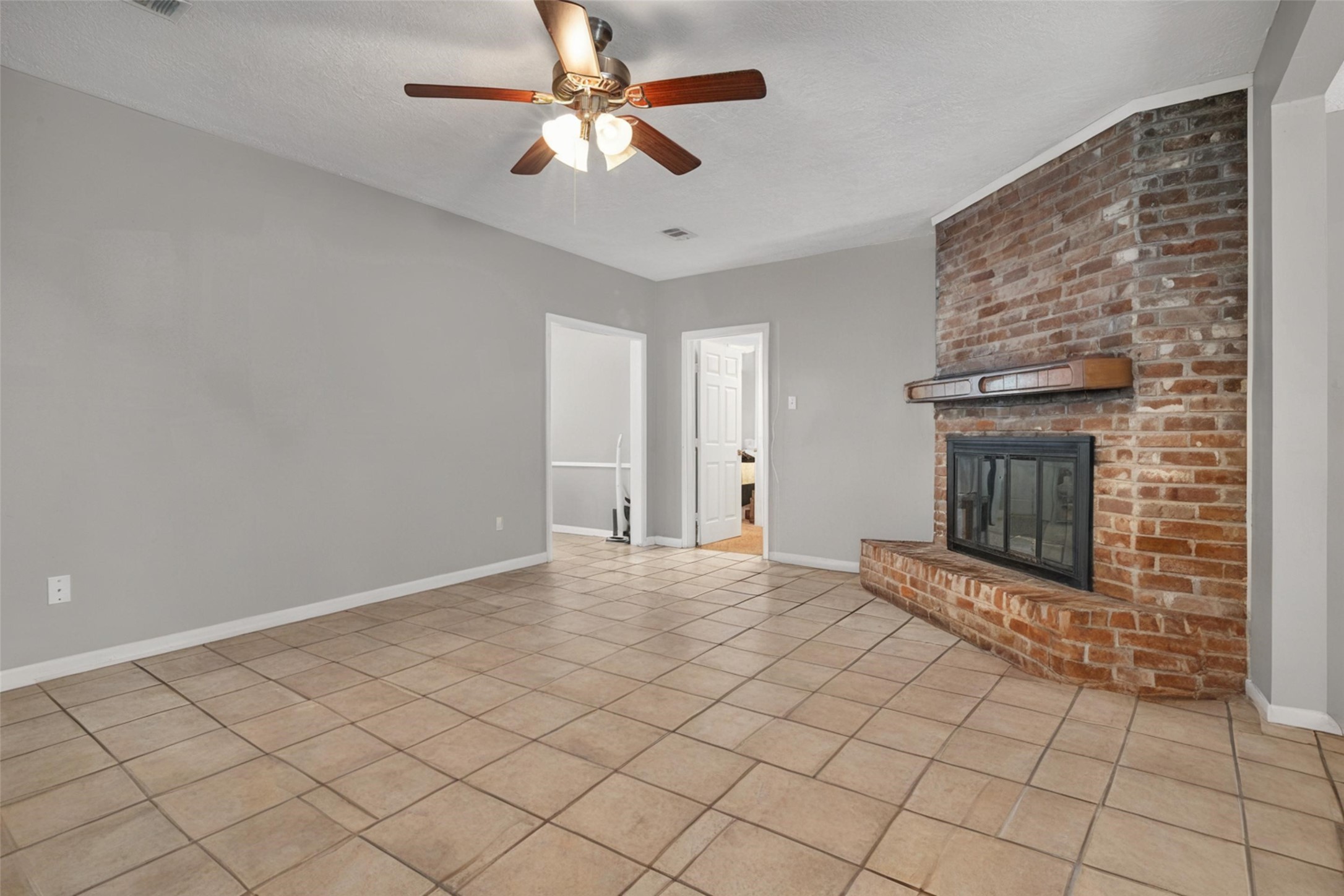 18230 Caprice Lane Houston, TX 77058 - Photo 26 of 34 an empty room with windows and ceiling fan