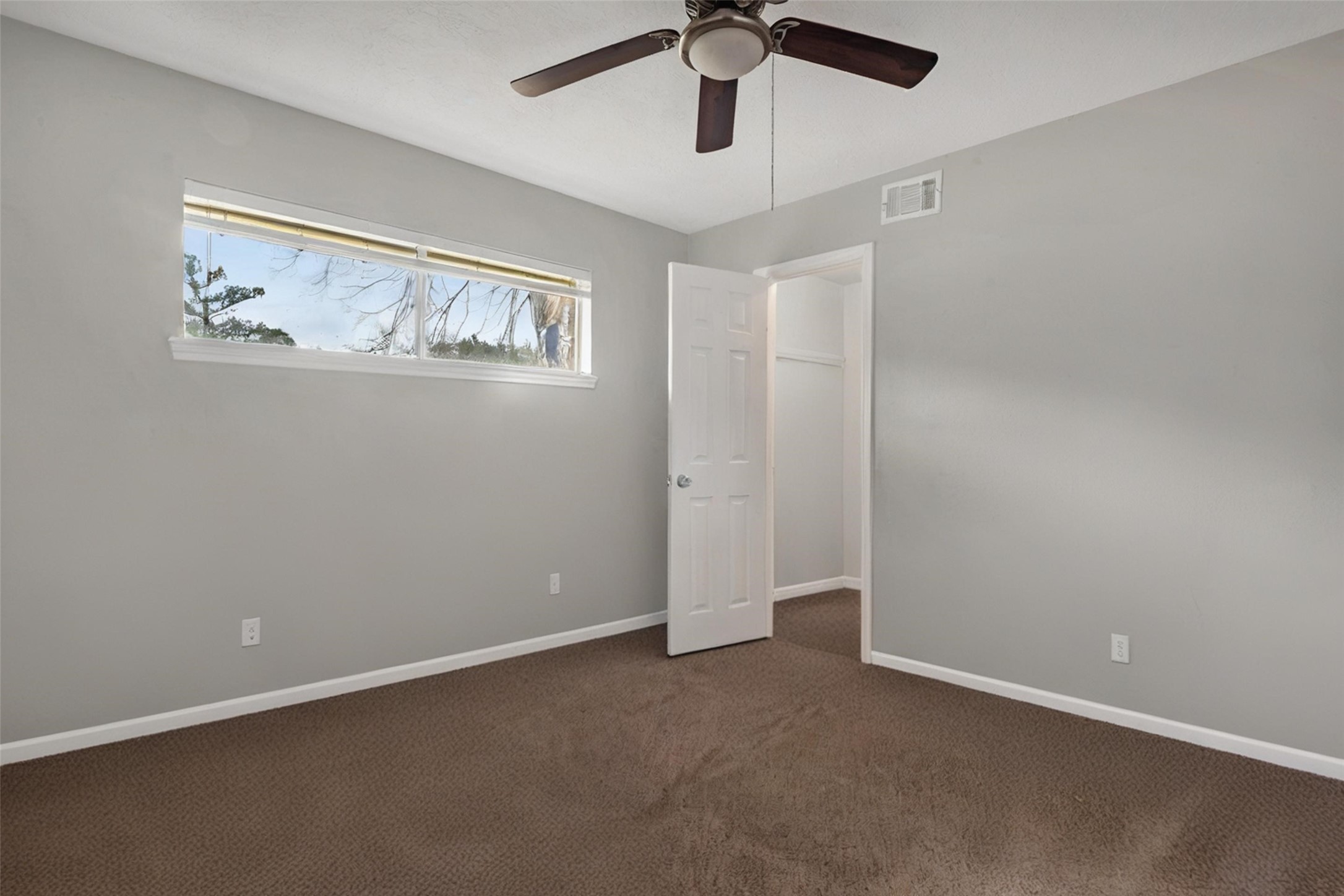 18230 Caprice Lane Houston, TX 77058 - Photo 29 of 34 an empty room with windows and fan