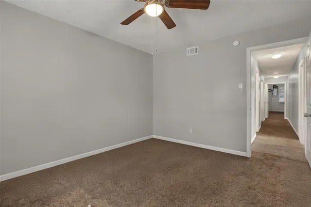 an empty room with a empty space and chandelier fan