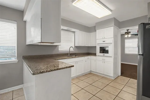 a kitchen with granite countertop cabinets and steel stainless steel appliances