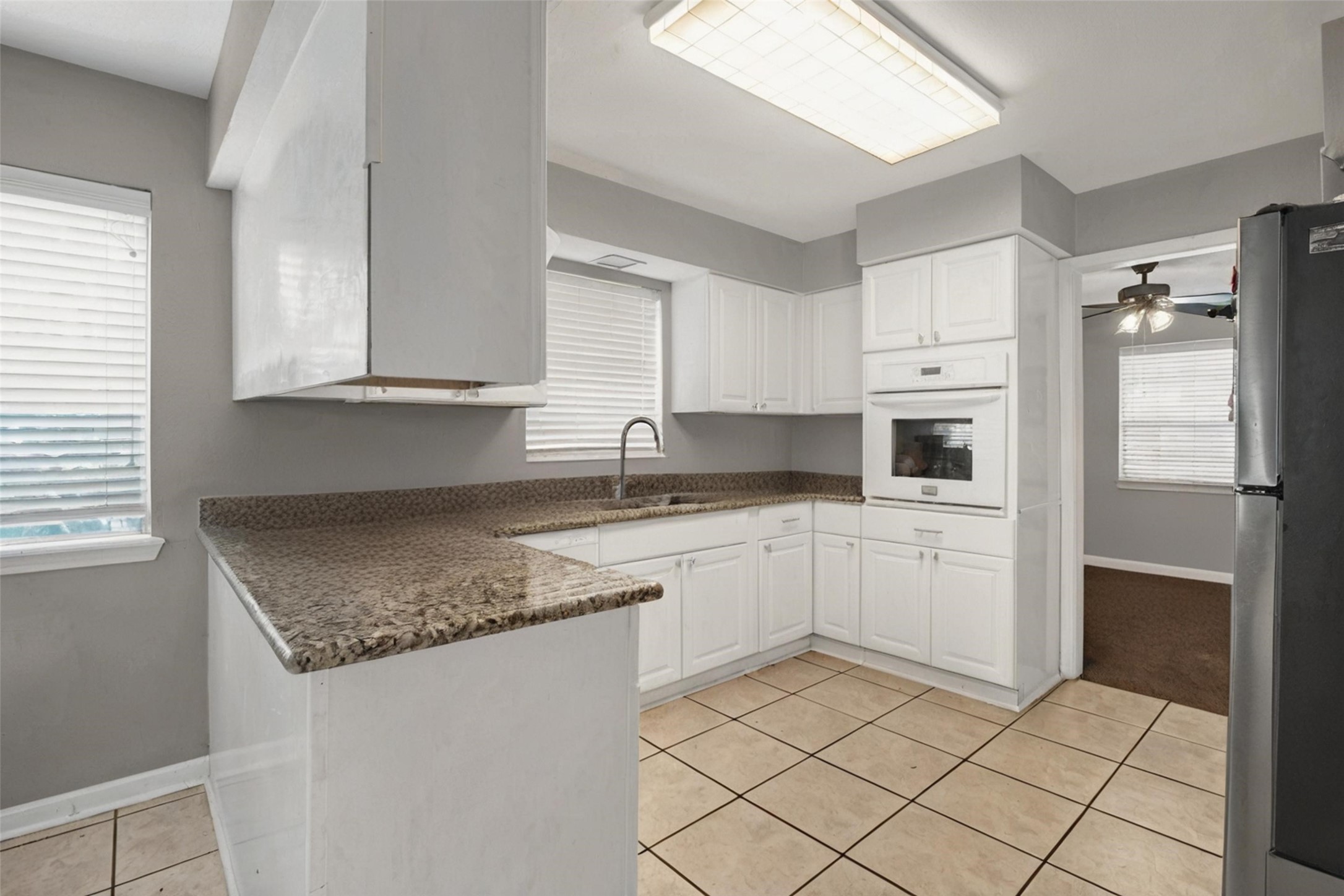 18230 Caprice Lane Houston, TX 77058 - Photo 33 of 34 a kitchen with granite countertop cabinets and steel stainless steel appliances