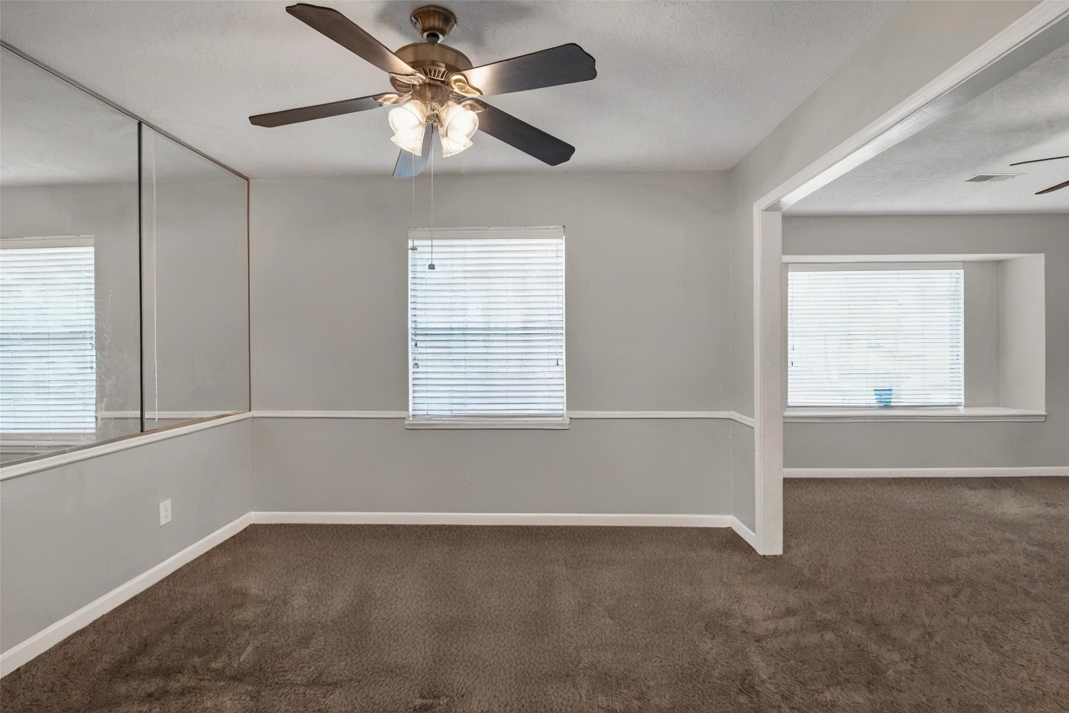 18230 Caprice Lane Houston, TX 77058 - Photo 6 of 34 an empty room with a window and a fan