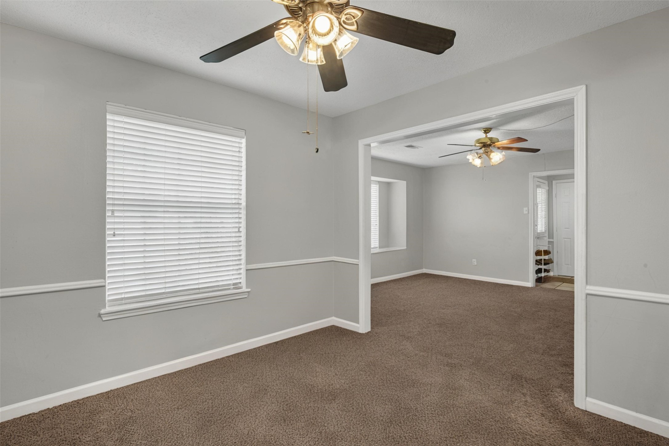 18230 Caprice Lane Houston, TX 77058 - Photo 9 of 34 a view of a livingroom with a ceiling fan and window
