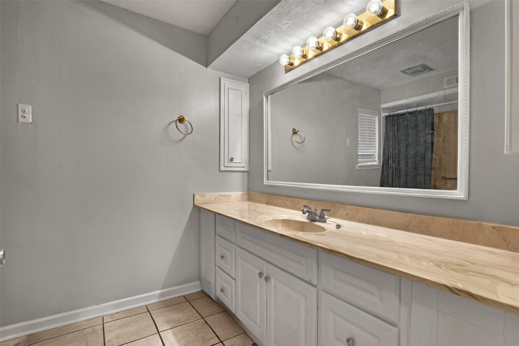 18230 Caprice Lane Houston, TX 77058 - Photo 10 of 34 a bathroom with a sink and a mirror