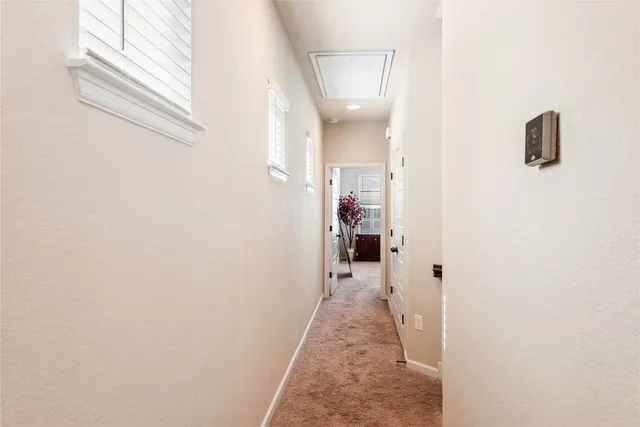 a hallway with kids room bathroom