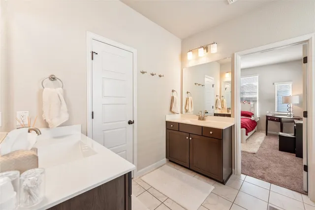a bathroom with a sink vanity and a mirror