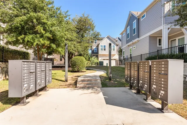 a view of a brick house with many windows