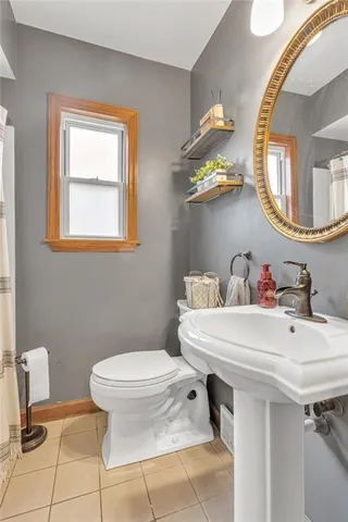 a bathroom with a sink mirror and toilet