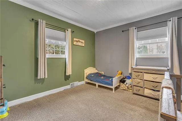 a living room with a bed and a window