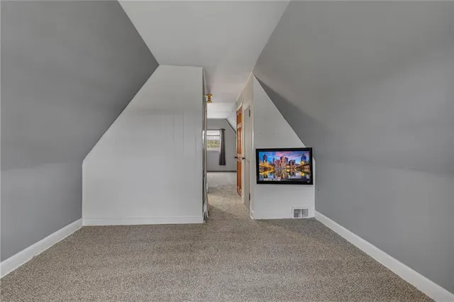 a view of a livingroom with wooden floor and entryway