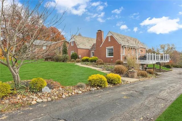 a view of a house with a yard and a garage
