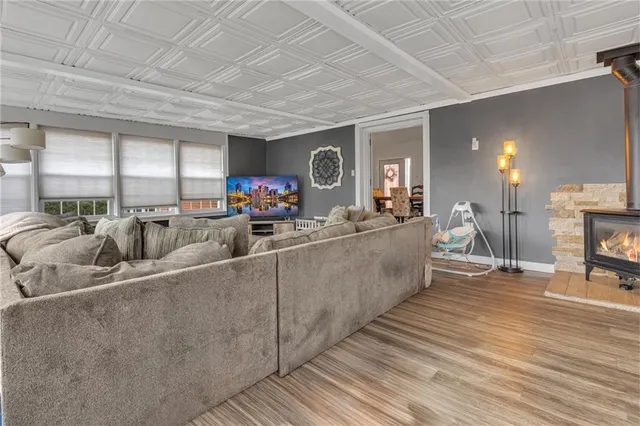 a living room with furniture a flat screen tv and a table