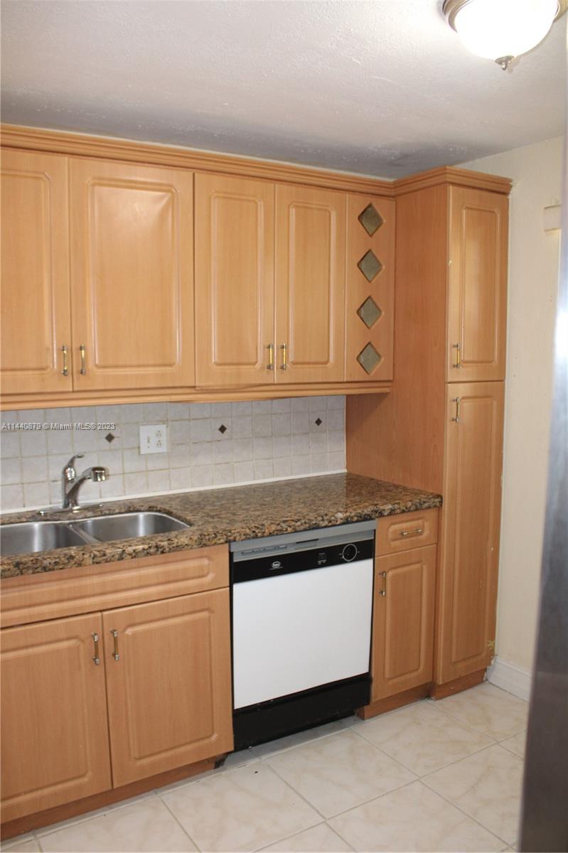 3490 Foxcroft Road, Unit B110 Miramar, FL 33025 - Photo 12 of 39 a kitchen with stainless steel appliances granite countertop a stove a sink and dishwasher