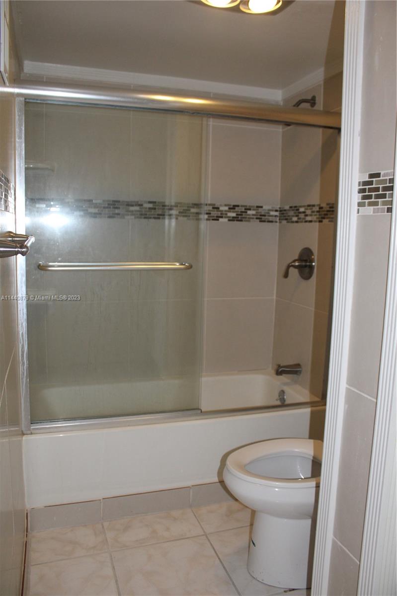 3490 Foxcroft Road, Unit B110 Miramar, FL 33025 - Photo 13 of 39 a bathroom with a shower a toilet and sink