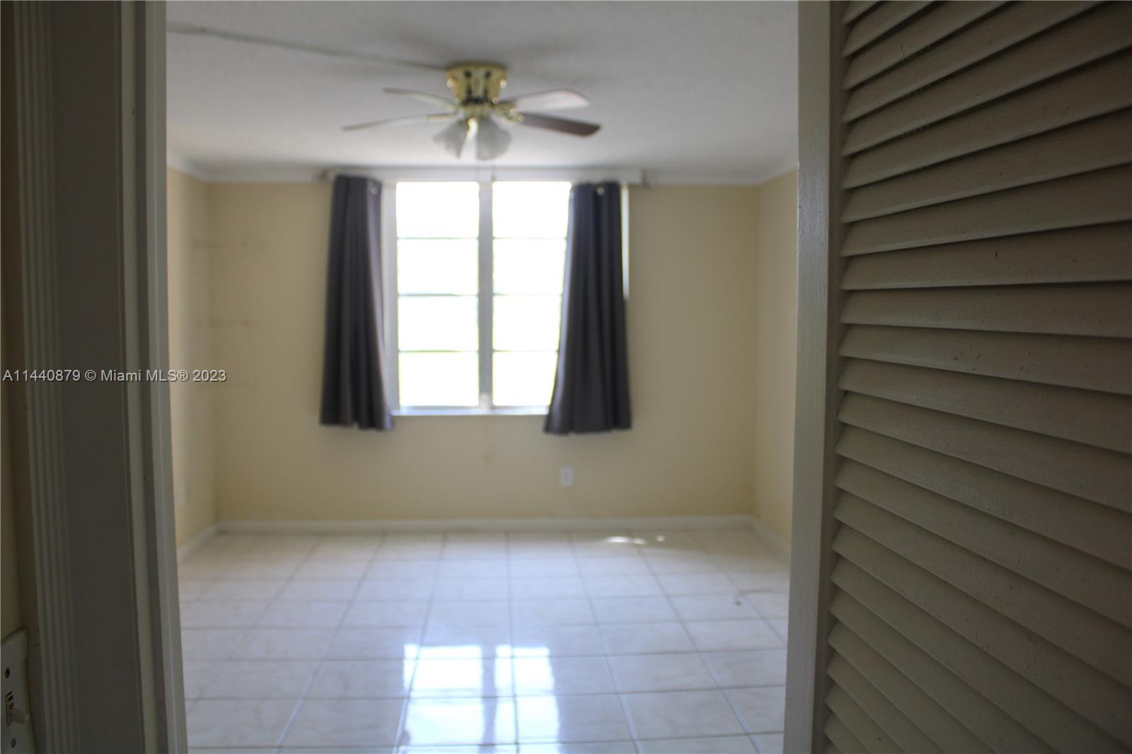3490 Foxcroft Road, Unit B110 Miramar, FL 33025 - Photo 17 of 39 a view of an empty room with a window