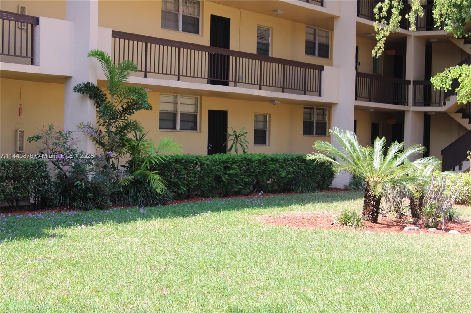 3490 Foxcroft Road, Unit B110 Miramar, FL 33025 - Photo 23 of 39 a view of a house with a yard and plants