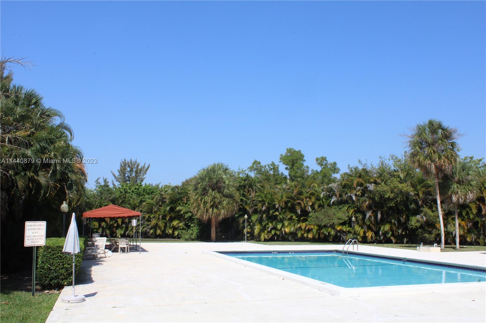 3490 Foxcroft Road, Unit B110 Miramar, FL 33025 - Photo 30 of 39 a view of a swimming pool with an outdoor seating