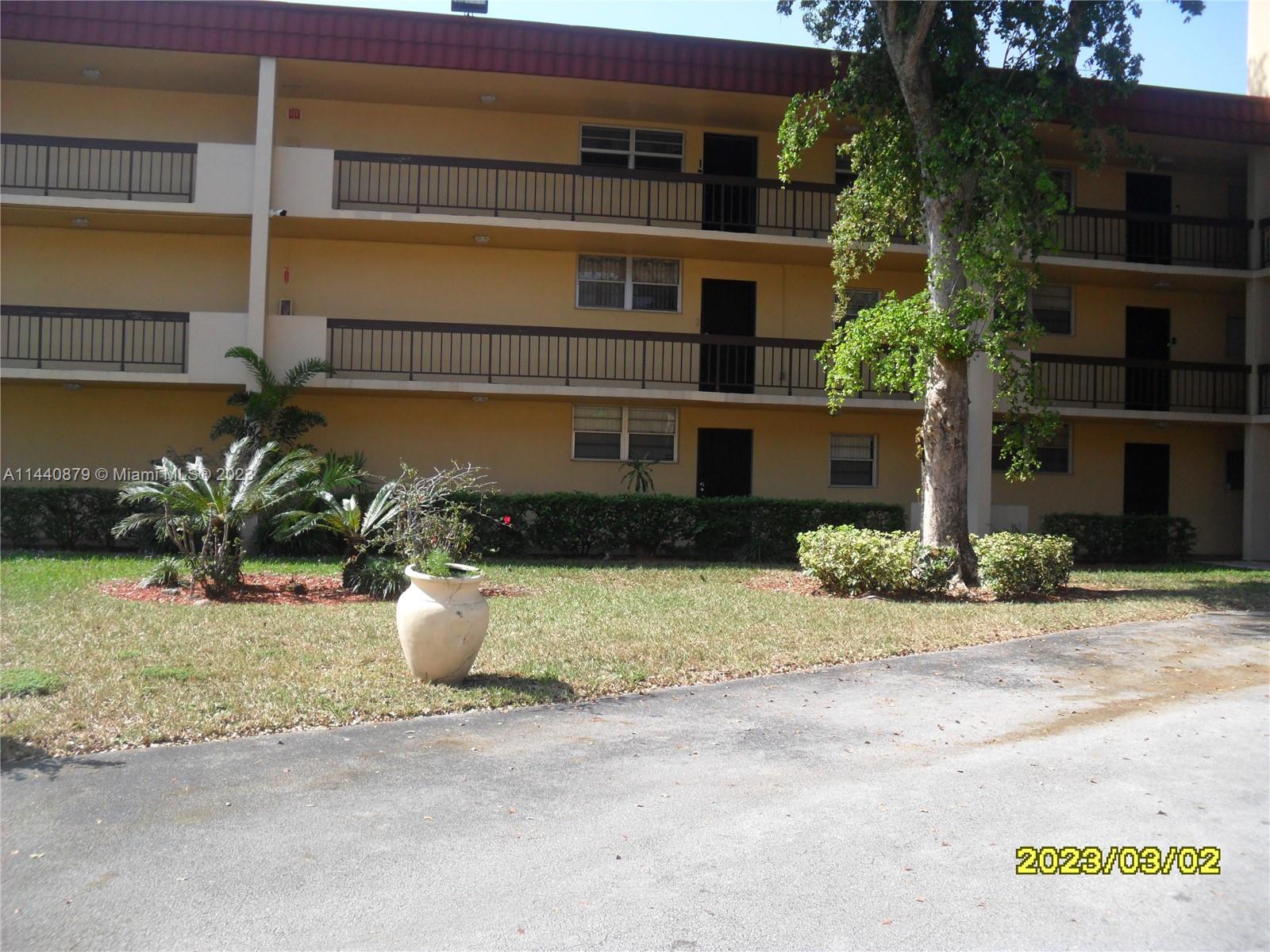 3490 Foxcroft Road, Unit B110 Miramar, FL 33025 - Photo 37 of 39 a front view of a house with a yard