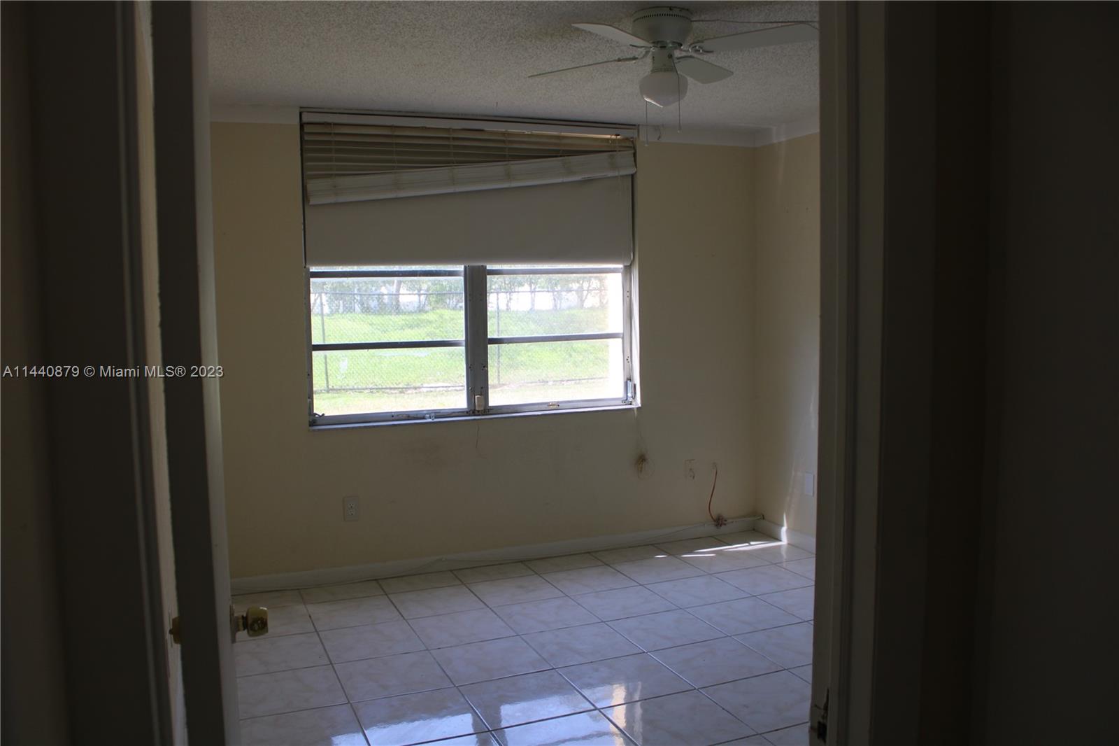 3490 Foxcroft Road, Unit B110 Miramar, FL 33025 - Photo 4 of 39 a view of an empty room with a window
