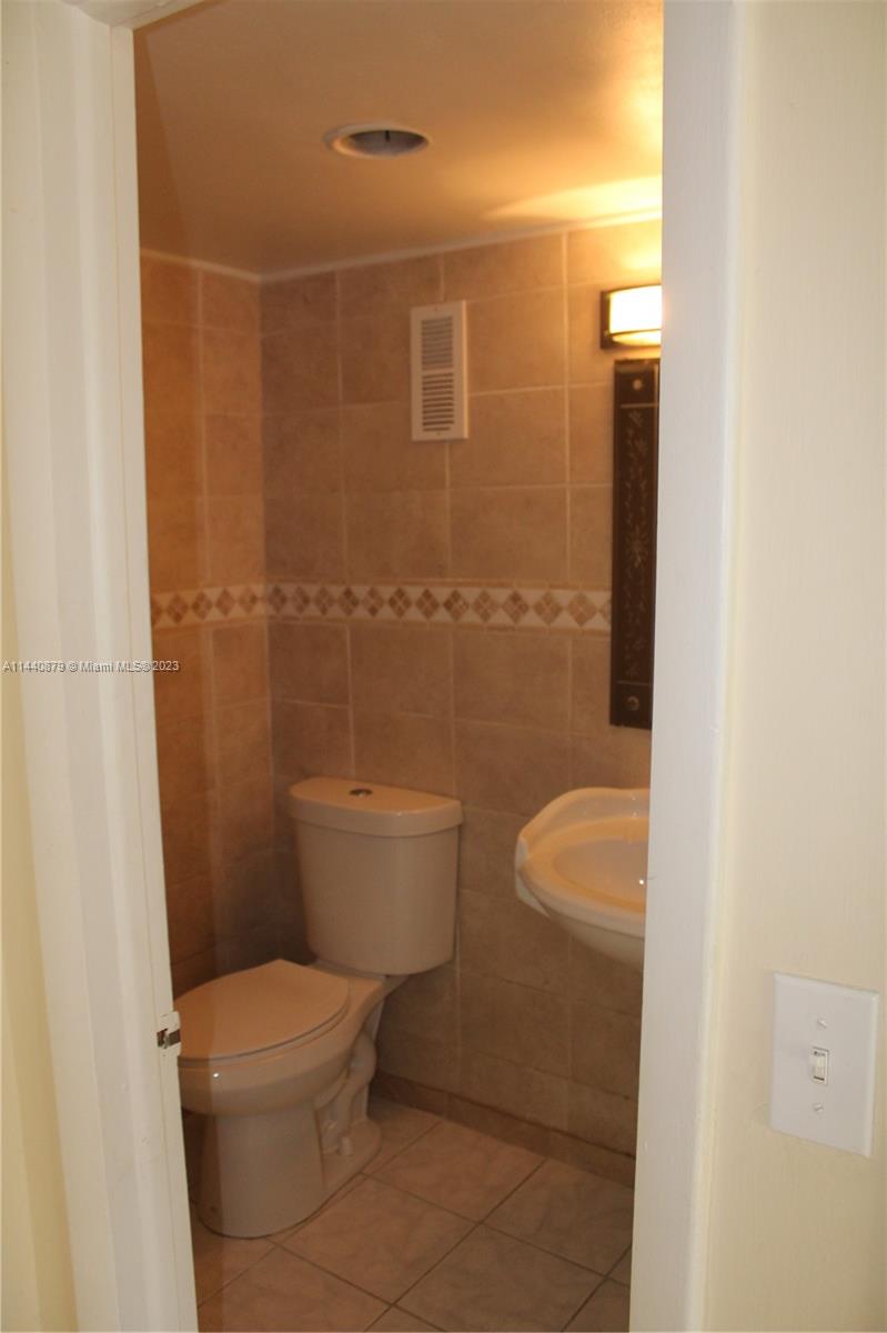 3490 Foxcroft Road, Unit B110 Miramar, FL 33025 - Photo 6 of 39 a bathroom with a toilet and a shower