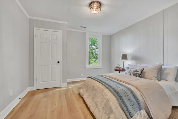 a bedroom with a bed and a window