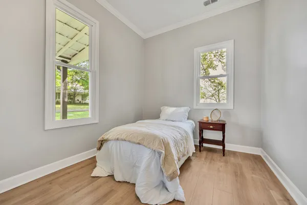 a bedroom with a bed and a window