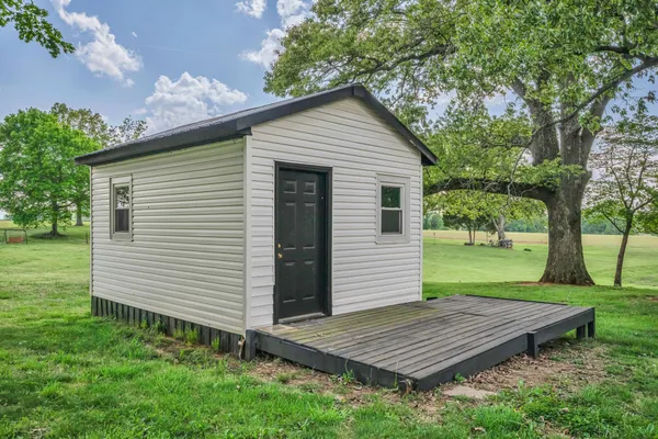 a view of a wooden deck in the backyard