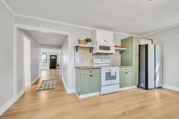 a kitchen with stainless steel appliances a refrigerator sink and cabinets