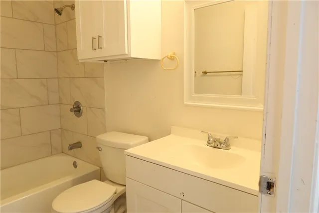 a bathroom with a sink a toilet and bathtub