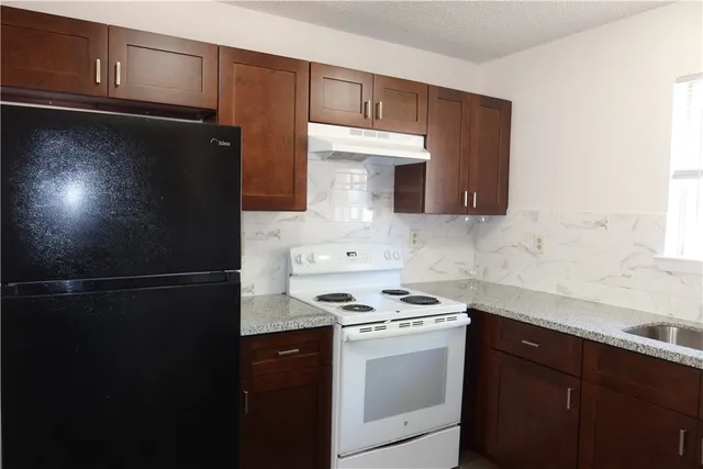 a kitchen with a refrigerator and cabinets