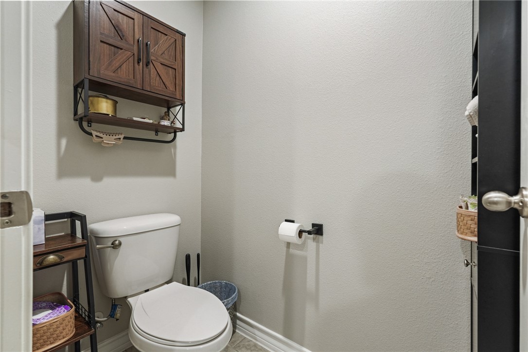 103 Donegal Street Sinton, TX 78387 - Photo 21 of 29 a white toilet sitting next to a bathroom sink