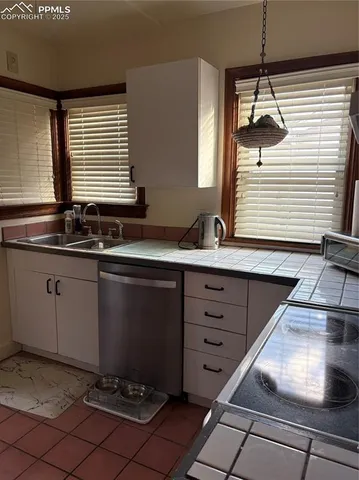 a kitchen with a sink and cabinets